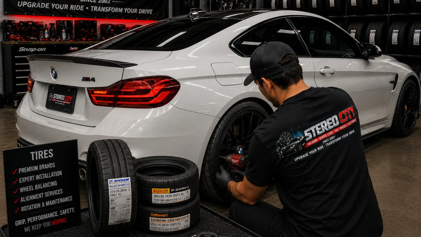 Technician fitting custom wheels to a white sports car