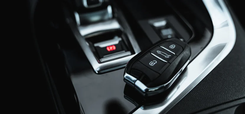 Remote start key fob resting on a car centre console