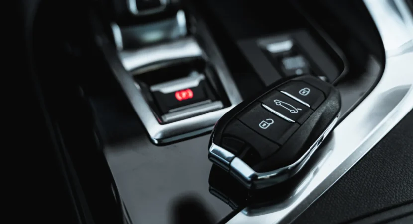 Remote start key fob resting on a car centre console